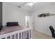 Comfortable bedroom with carpet flooring, desk and a white ceiling fan at 2651 Sunrise Blvd, Mount Dora, FL 32757