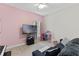 Comfortable bedroom with a cheerful pink accent wall, perfect for relaxing or play at 2651 Sunrise Blvd, Mount Dora, FL 32757