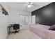 Bright bedroom featuring a desk, black accent wall, and comfortable furnishings at 2651 Sunrise Blvd, Mount Dora, FL 32757