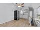 Kitchenette equipped with a fridge, sink, white cabinets, and wood-look flooring at 2651 Sunrise Blvd, Mount Dora, FL 32757