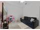 Cozy living room with a plush sofa, television, and a dollhouse at 2651 Sunrise Blvd, Mount Dora, FL 32757