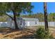 Exterior view of outbuilding with blue chairs and a fenced yard at 2651 Sunrise Blvd, Mount Dora, FL 32757