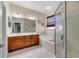 Bathroom with double vanity, soaking tub, and glass enclosed shower, providing a spa-like experience at 26712 Augusta Springs Cir, Leesburg, FL 34748