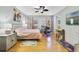 Cozy bedroom with hardwood floors, a comfortable bed, and windows offering natural light at 26712 Augusta Springs Cir, Leesburg, FL 34748