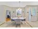 Dining room with tile flooring, contemporary table and chairs, and elegant lighting fixture at 26712 Augusta Springs Cir, Leesburg, FL 34748