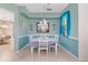 Dining room with table and chairs, light blue walls with white trim, and a window with sheer curtains at 26712 Augusta Springs Cir, Leesburg, FL 34748