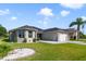 Charming single-story home with well-maintained landscaping, a driveway, and a two-car garage at 26712 Augusta Springs Cir, Leesburg, FL 34748