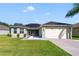Charming home with a two-car garage, solar panels, lovely lawn, and well-kept landscaping at 26712 Augusta Springs Cir, Leesburg, FL 34748