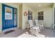 Inviting front porch with rocking chairs and decorative door with glass inserts. A relaxing spot to unwind at 26712 Augusta Springs Cir, Leesburg, FL 34748