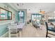 Open concept living space with dining area, tile floors, and large windows. Bright and airy at 26712 Augusta Springs Cir, Leesburg, FL 34748