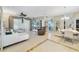 Open floor plan with tile flooring, white sofa, ceiling fan, and large windows offering natural light at 26712 Augusta Springs Cir, Leesburg, FL 34748