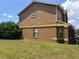 Side view of the two-story home, showing the well-maintained lawn and architectural details at 301 Blue Bayou Dr, Kissimmee, FL 34743