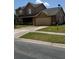 Two-story home showcasing a spacious driveway, attached garage, and manicured lawn at 301 Blue Bayou Dr, Kissimmee, FL 34743