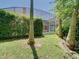 Backyard with healthy green lawn and a peekaboo view of screened-in pool and lanai at 3020 Zaharias Dr, Orlando, FL 32837