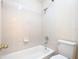 Bathroom with a tiled shower-tub, a toilet, and neutral walls at 3020 Zaharias Dr, Orlando, FL 32837