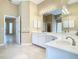 Bathroom boasts double sinks, white cabinetry, and a well-lit vanity area at 3020 Zaharias Dr, Orlando, FL 32837