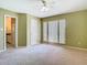 Bedroom featuring neutral walls, carpet floors, and an adjoining door to the bathroom at 3020 Zaharias Dr, Orlando, FL 32837