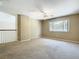 Spacious bonus room featuring neutral walls, a ceiling fan, and natural light through a large window at 3020 Zaharias Dr, Orlando, FL 32837