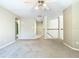 Upstairs bonus room with neutral decor leads to the stairway with a white railing at 3020 Zaharias Dr, Orlando, FL 32837