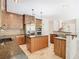 Spacious kitchen featuring granite counters, stainless steel appliances, an island cooktop, and ample cabinet space at 3020 Zaharias Dr, Orlando, FL 32837