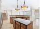 Well-appointed kitchen featuring granite countertops, an island cooktop, custom cabinets, and open access to the living areas at 3020 Zaharias Dr, Orlando, FL 32837