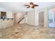 Living room with tiled floors, a stairway, and a partial view into a kitchen at 3020 Zaharias Dr, Orlando, FL 32837