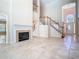 Living room with a fireplace, stairs to the second floor, and an open floor plan with high ceilings at 3020 Zaharias Dr, Orlando, FL 32837