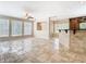 Open living room with tile flooring, a ceiling fan, bright windows, and a view into the kitchen at 3020 Zaharias Dr, Orlando, FL 32837