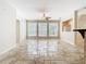 Open living room with tile flooring, a ceiling fan, bright windows, and view to an adjacent room at 3020 Zaharias Dr, Orlando, FL 32837