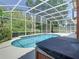 Screened in pool and spa with an outdoor living space at 3020 Zaharias Dr, Orlando, FL 32837