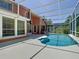 Inviting screened pool and spa area surrounded by lush landscaping at 3020 Zaharias Dr, Orlando, FL 32837