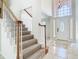Elegant staircase featuring wood railings and a decorative front door at 3020 Zaharias Dr, Orlando, FL 32837