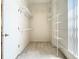 A white walk-in closet boasts shelving and ample storage space at 3020 Zaharias Dr, Orlando, FL 32837