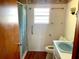 Cozy bathroom with a shower, toilet, and sink at 311 E Bridgers Ave, Auburndale, FL 33823
