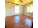 Bright bedroom with tiled floors, featuring two windows for plenty of natural light at 311 E Bridgers Ave, Auburndale, FL 33823