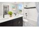 Well-appointed bathroom featuring dual sinks, a bathtub with shower, and elegant tile flooring at 3189 Douglas Fir Dr, Apopka, FL 32703