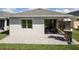 Well-maintained backyard featuring a paved patio and outdoor fireplace at 3289 Songbird Cir, Harmony, FL 34773