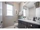 Well-lit bathroom with a stylish vanity, framed art, and a large window at 3289 Songbird Cir, Harmony, FL 34773