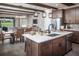 Spacious kitchen with an island, stone backsplash, and dining area at 3289 Songbird Cir, Harmony, FL 34773