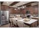 Modern kitchen featuring stainless steel appliances, a spacious island, and stylish pendant lighting at 3289 Songbird Cir, Harmony, FL 34773