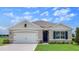 Charming single-Gathering home featuring a manicured lawn and an attached two-car garage at 33640 Seattle Slew Dr, Sorrento, FL 32776