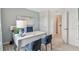 Bright home office featuring blue chairs, large white desk and view through open door to hall at 33640 Seattle Slew Dr, Sorrento, FL 32776