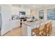 Inviting kitchen featuring an island with seating, granite counters, and stainless steel appliances at 33640 Seattle Slew Dr, Sorrento, FL 32776