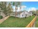 Aerial view of the home's backyard with a white fence, trees, and a covered back patio at 341 Bahia Cir, Longwood, FL 32750