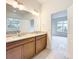 Bright bathroom featuring double vanity with granite countertop and wood cabinets with tile floors at 341 Bahia Cir, Longwood, FL 32750
