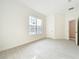 Bright and airy bedroom with neutral walls, tile floor, large window, and a doorway at 341 Bahia Cir, Longwood, FL 32750