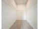 Walk-in closet featuring white wire shelving and wood-look tile flooring at 341 Bahia Cir, Longwood, FL 32750