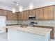 Kitchen featuring an island, stainless appliances and a gray tile backsplash at 341 Bahia Cir, Longwood, FL 32750
