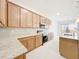 Bright kitchen with stainless steel appliances, granite countertops, and sleek backsplash at 341 Bahia Cir, Longwood, FL 32750