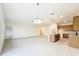 Open concept living area with tile flooring and ample natural light, connected to kitchen at 341 Bahia Cir, Longwood, FL 32750